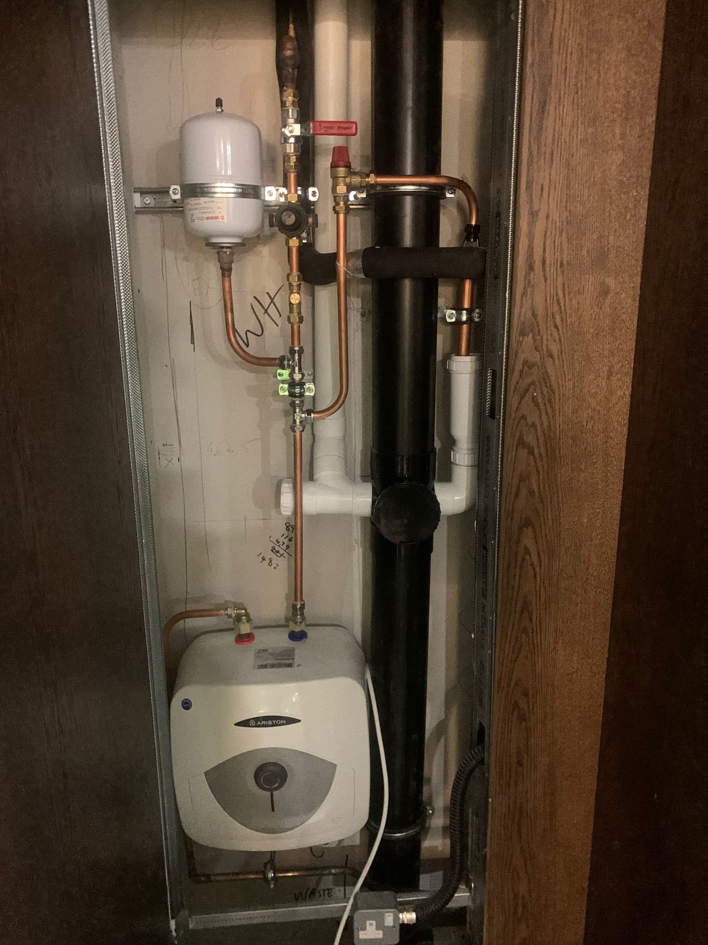 Ariston water heater and copper pipework in a Dublin riser cupboard