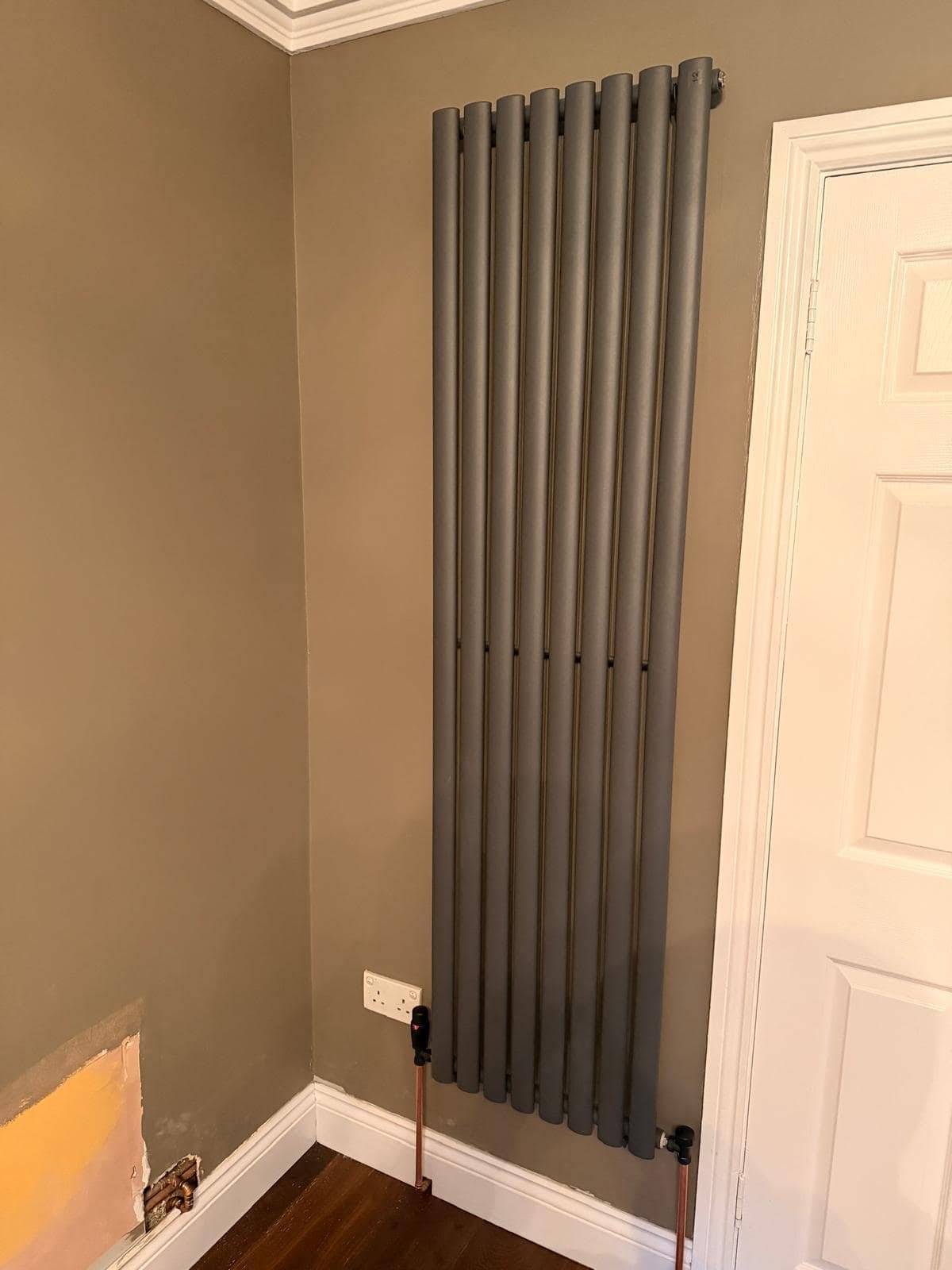 Finished anthracite vertical designer radiator installed in a Dublin home